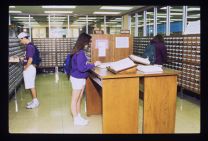 Students using library card catalog